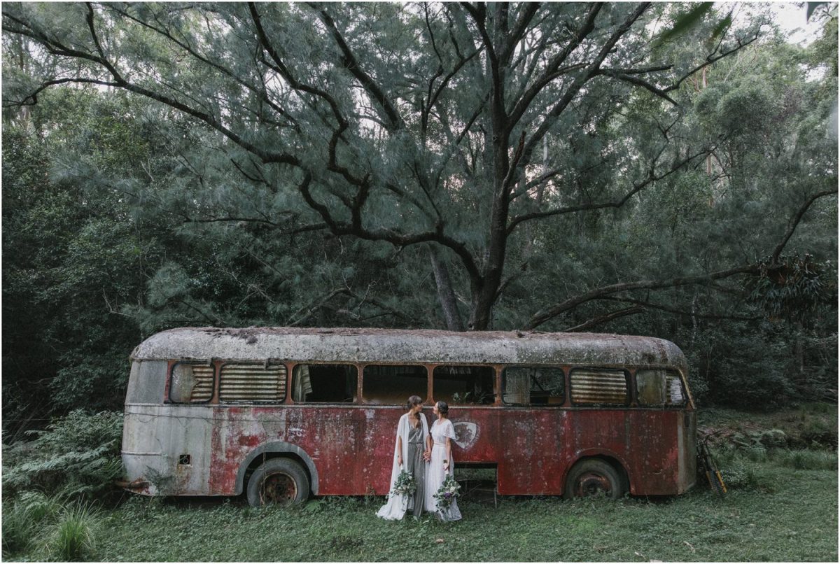 Newly married couple in front of an old abandoned bus after their kangaroo valley same sex wedding ceremony