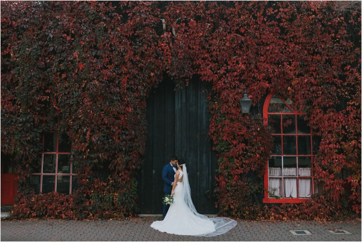 A newly married couple stand in front of amazing autumn colours at their Peppers Craigieburn wedding in Bowral