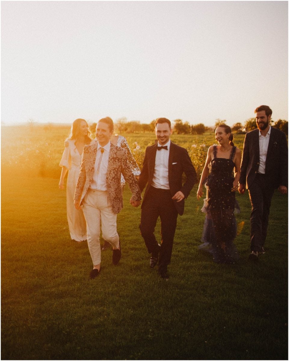 A bridal party walk at sunset at a beautiful Merribee House wedding