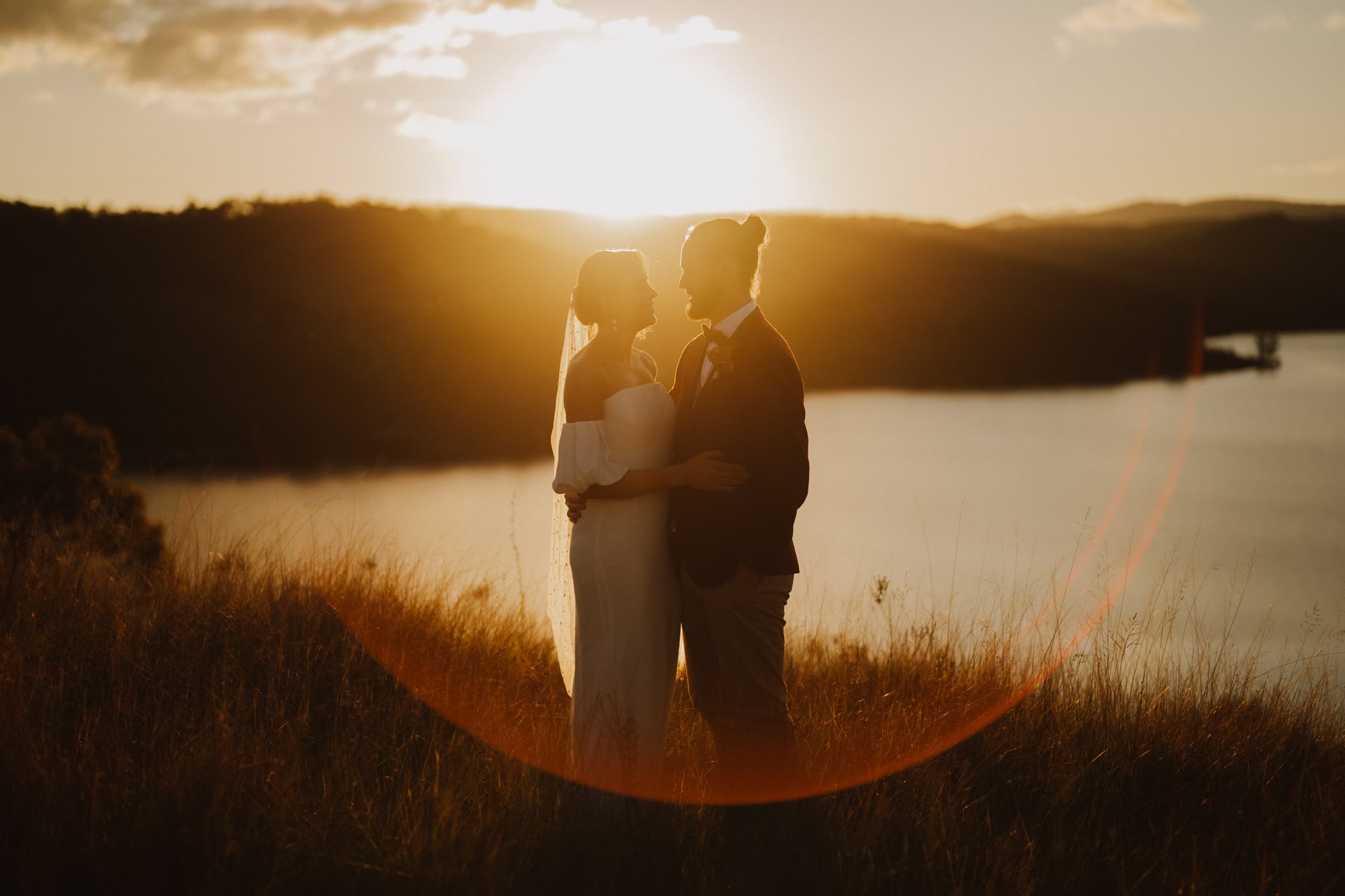A bride and groom embrace at sunset at their Seclusions Blue Mountains Wedding
